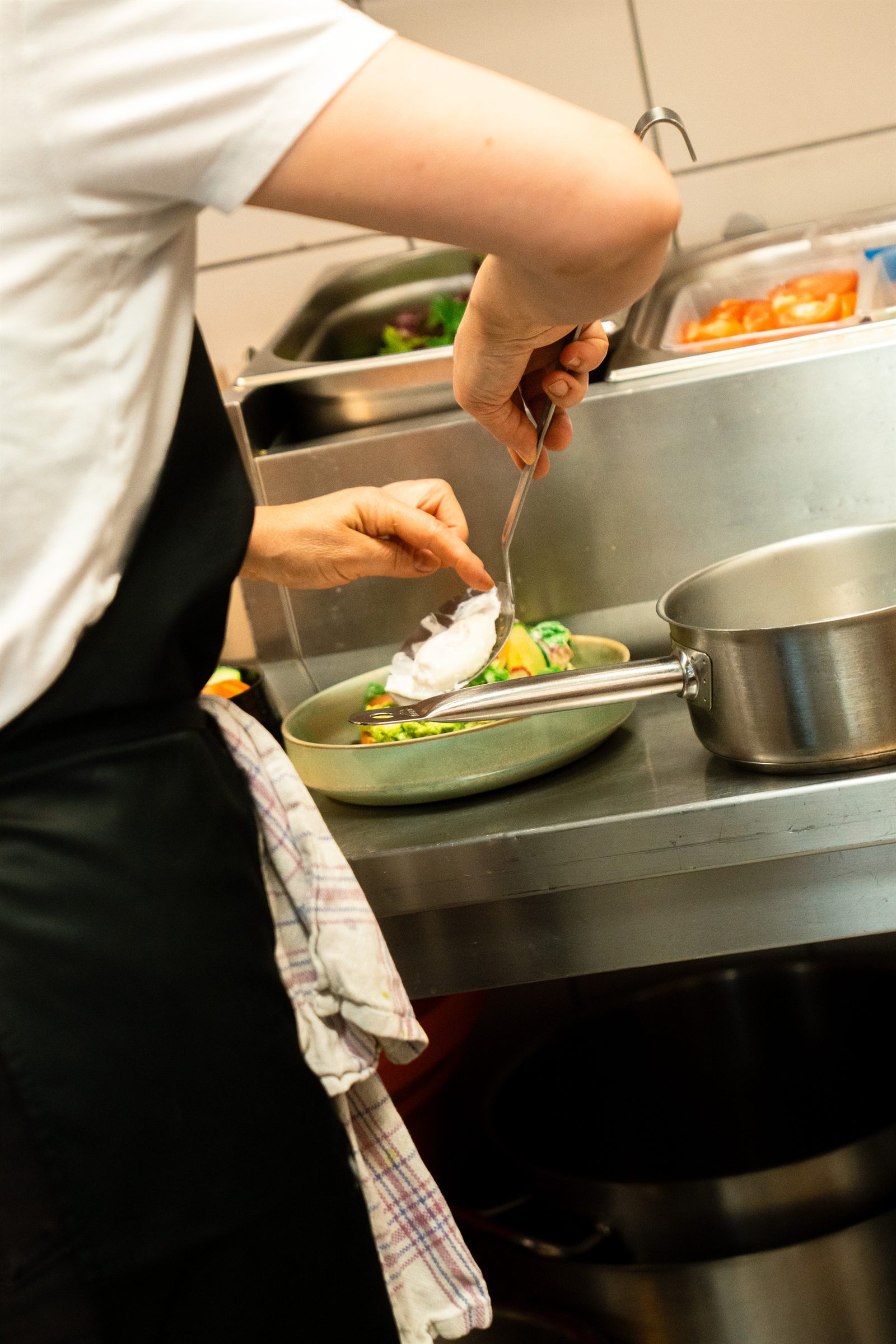 A chef plating in the kitchen